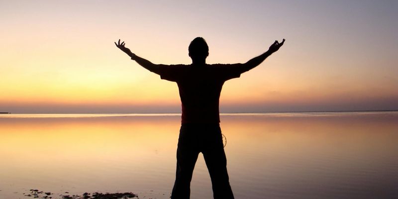 Silhouette of a person in a balancing stance.